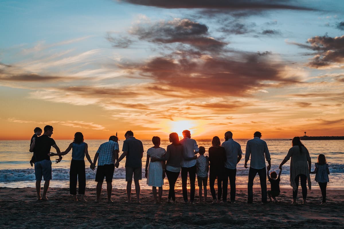 group of people at sunset on the beach