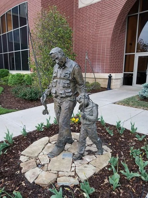 Bronze of a grandpa and boy going fishing
